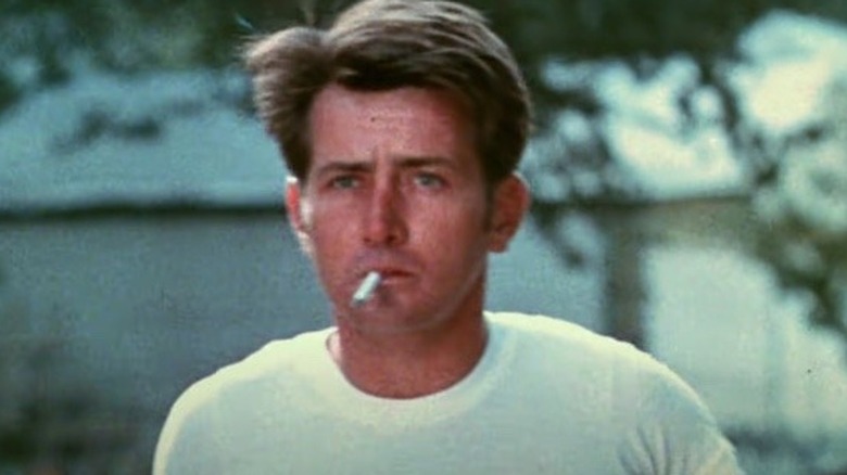 Kit Carruthers smoking cigarette