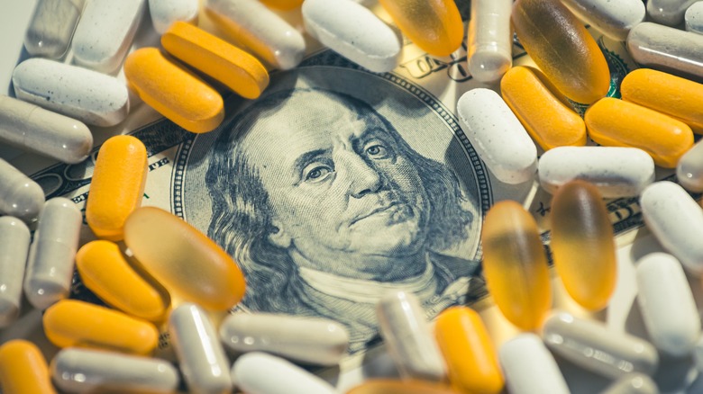 Pills cover a $100 bill