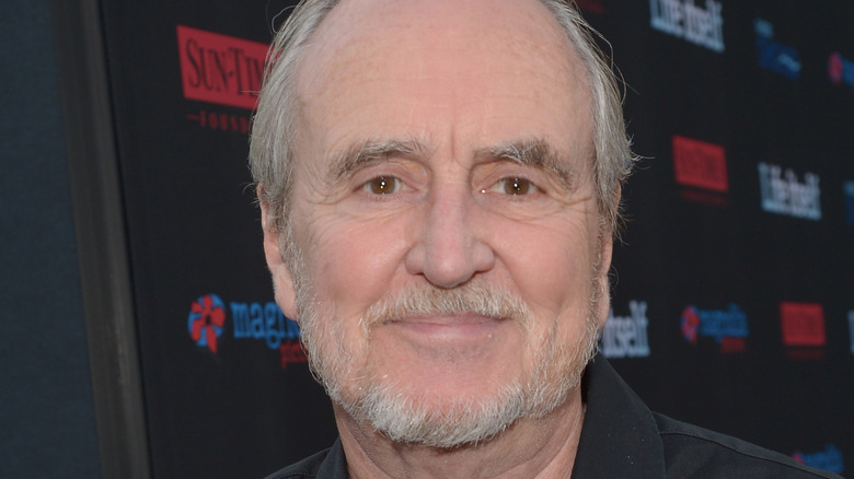 Wes Craven on red carpet looking at camera