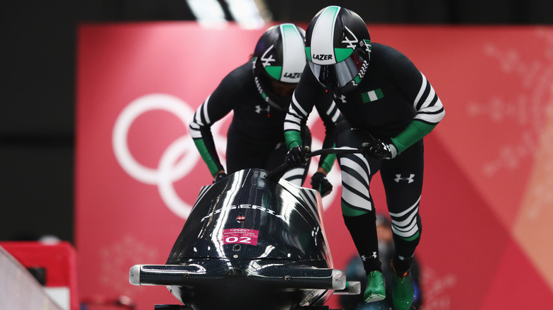 Seun Adigun and Ngozi Onwumere pushing sled