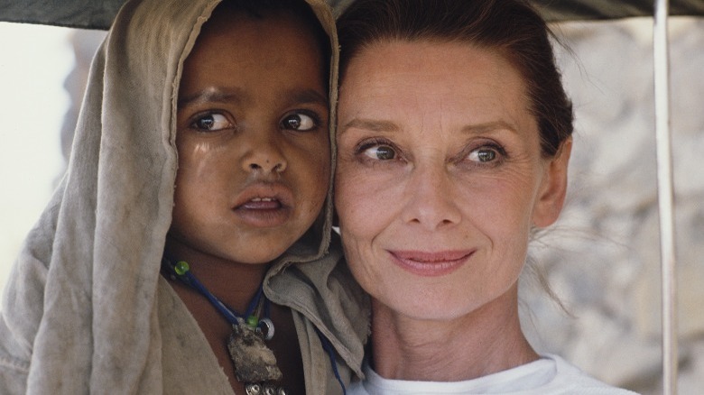 audrey hepburn carrying child