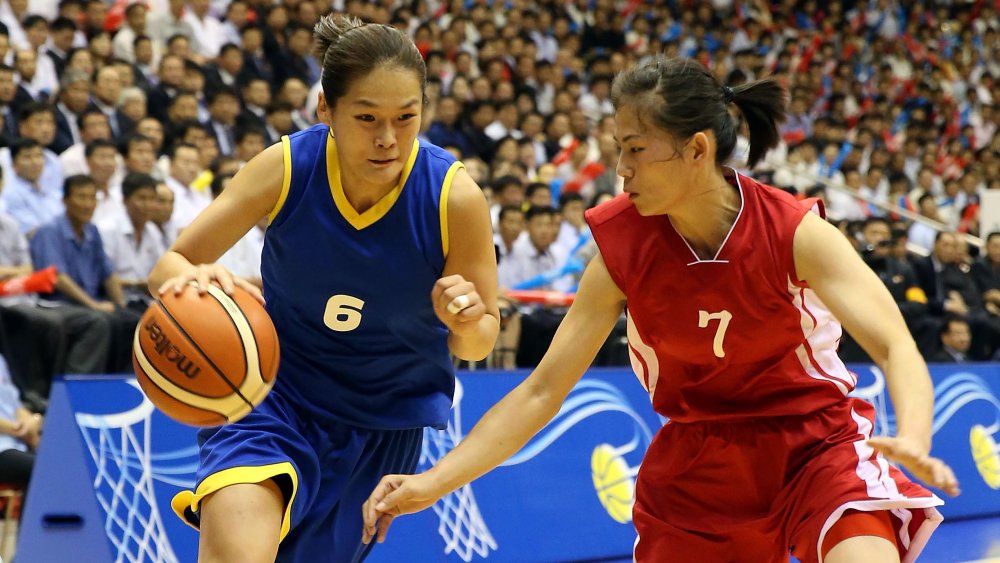 Female North Korean basketball players during a game.