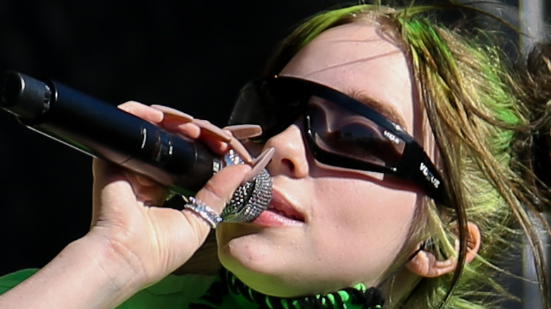 Green-haired Billie Eilish performing