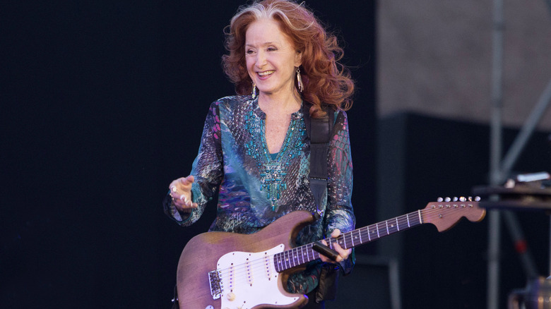 Bonnie Raitt on stage with guitar