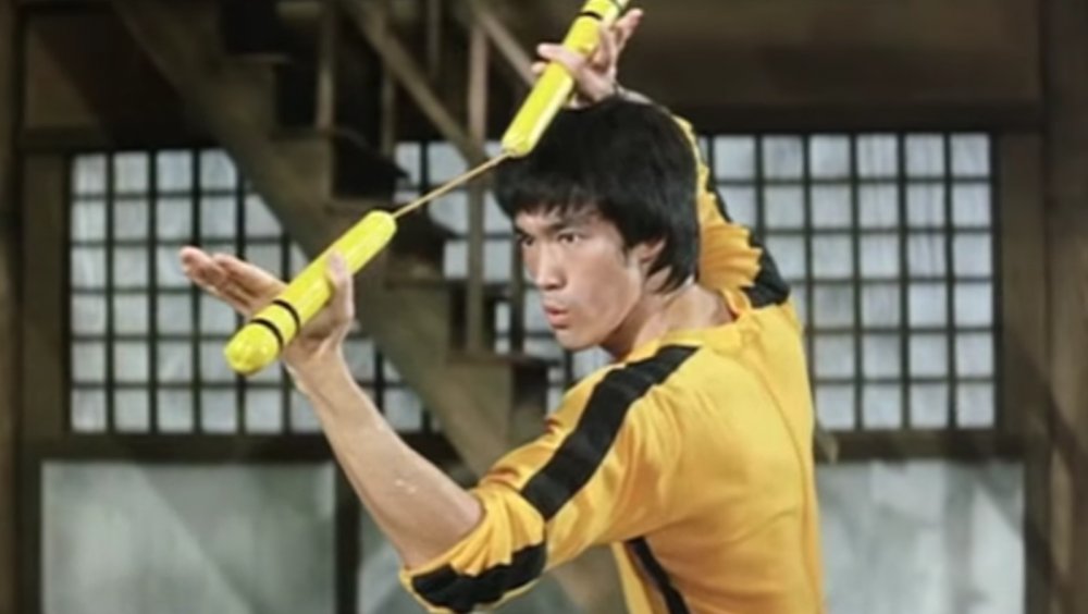 Bruce Lee with nunchucks