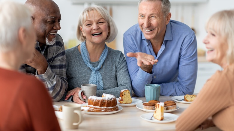 people at a table drinking tea and taking