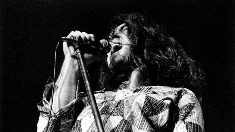 Ian Paice singing into a microphone during a Deep Purple concert in 1972