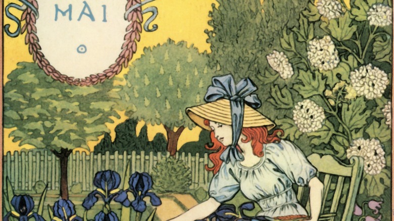 a calendar image for the month of May: a woman picking flowers