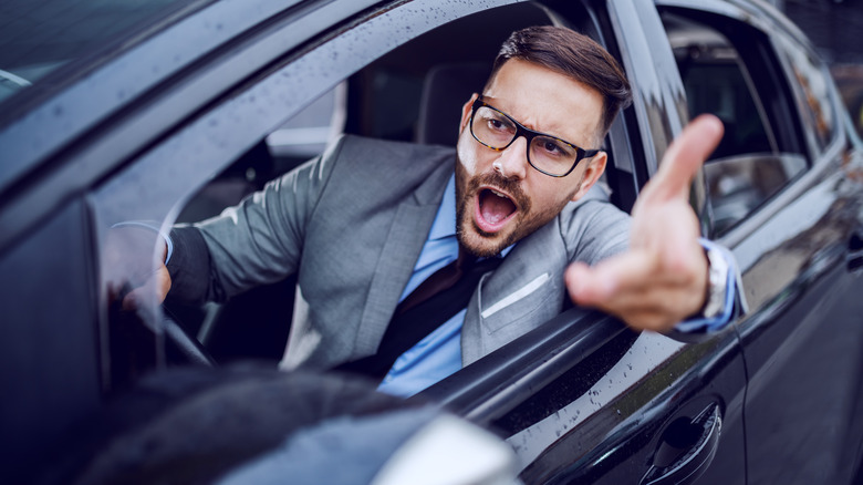 Man gesturing from car