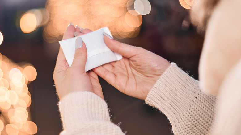 woman holding hand warmer