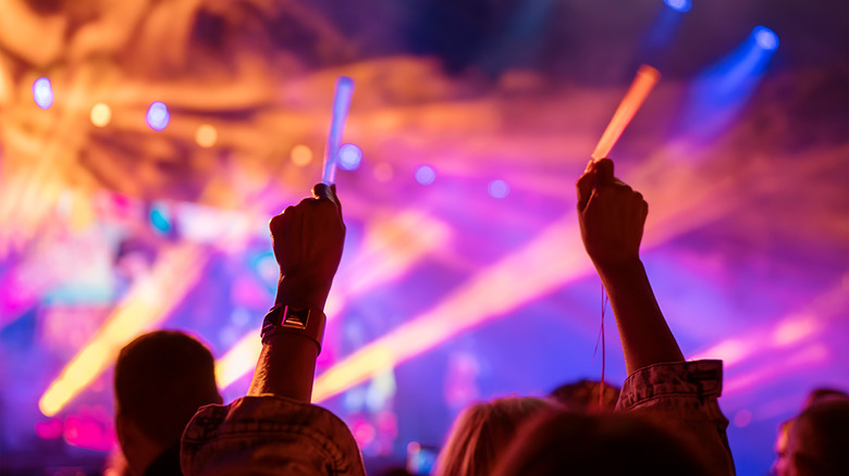 partiers holding glowsticks