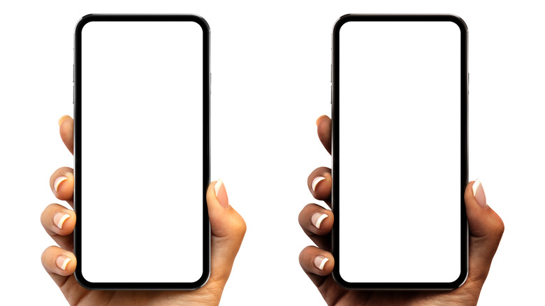 Two hands holding cellphones  