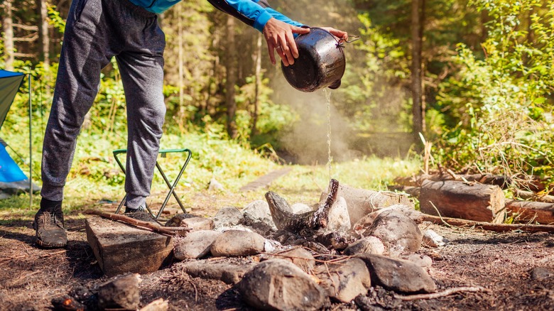 Extinguishing a campfire with water