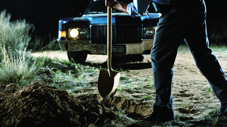 Killer digging grave by car