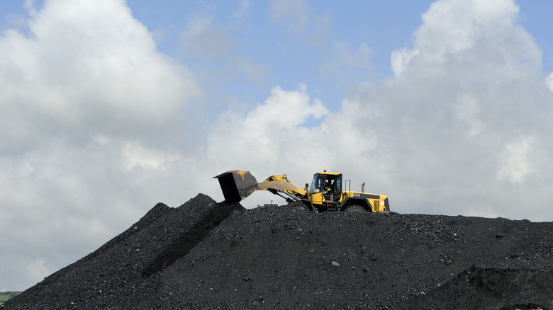 yellow digger moving coal