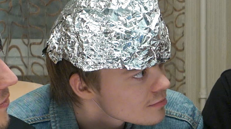 Individuals wearing foil hats