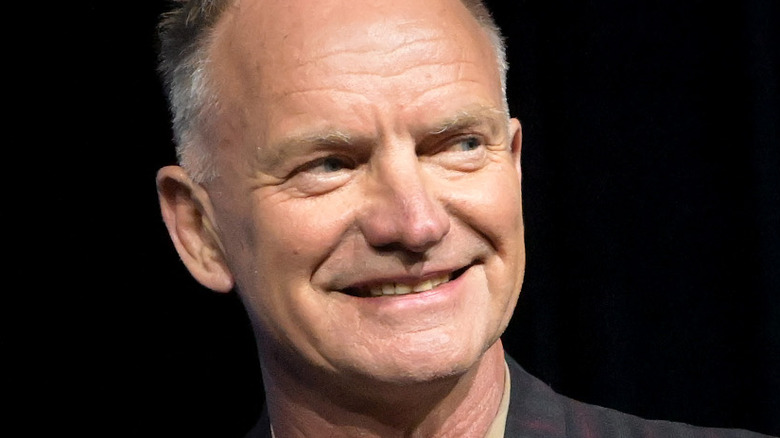 Sting smiling onstage in 2022
