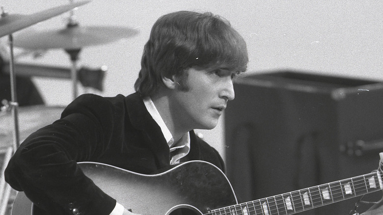 John Lennon plays guitar