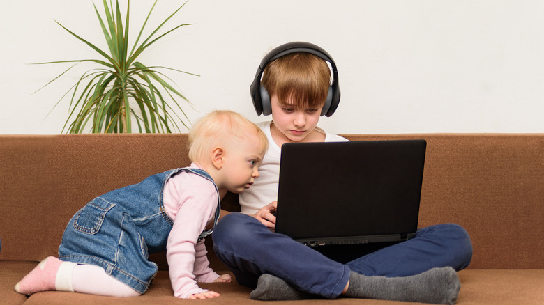 two brothers watching a computer screen