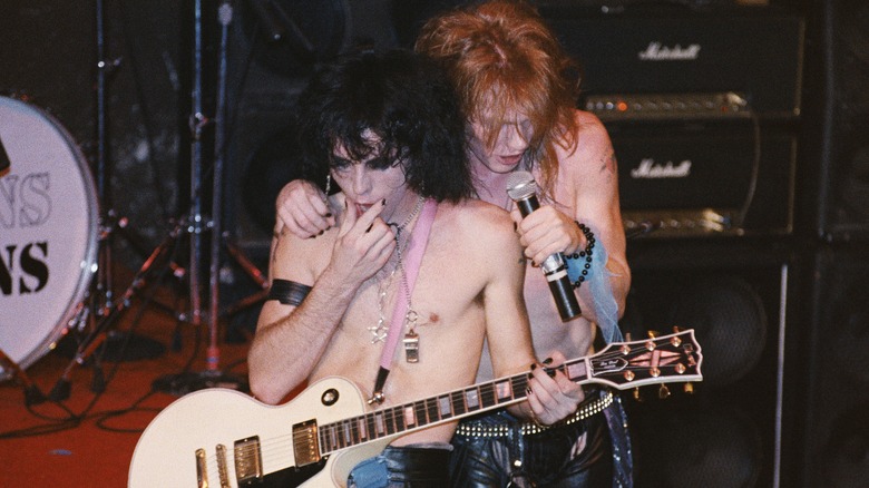 Tracii Guns and Axl Rose performing