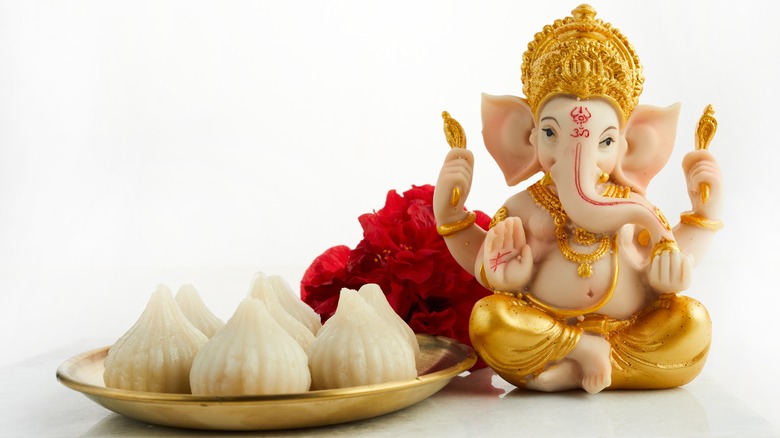 ganesha statue and modak dessert