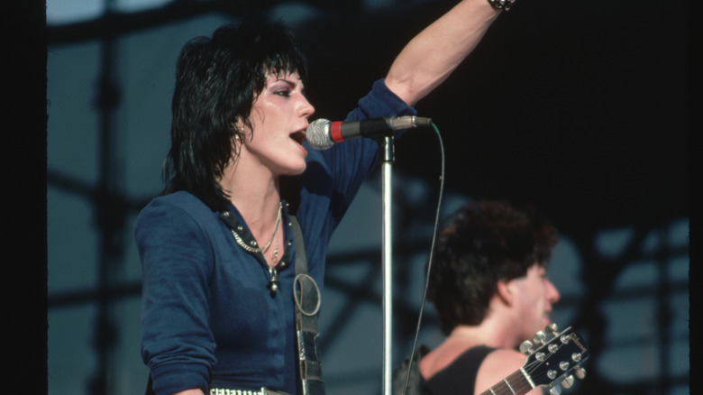 Joan Jett performing hand raised