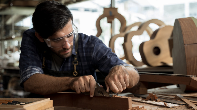 Luthier building acoustic guitar