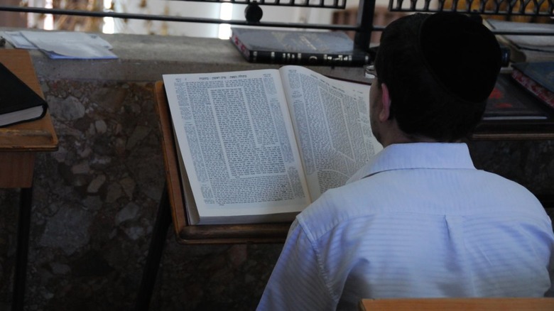 man studying talmud