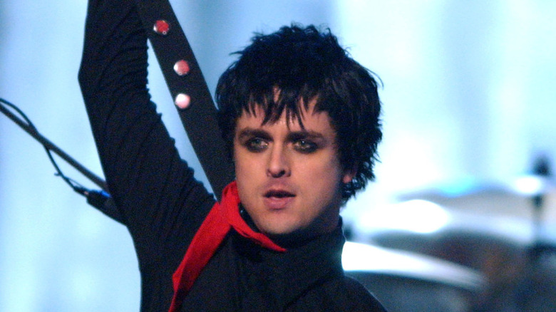Billie Joe Armstrong of Green Day hoists guitar