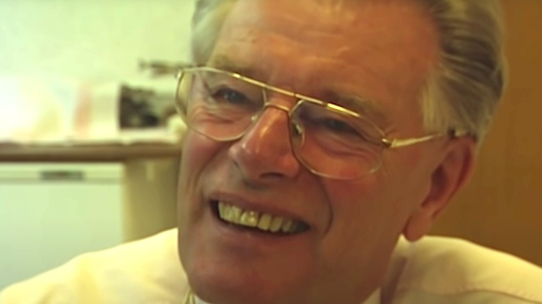 Dr Jan Karbaat smiling in glasses