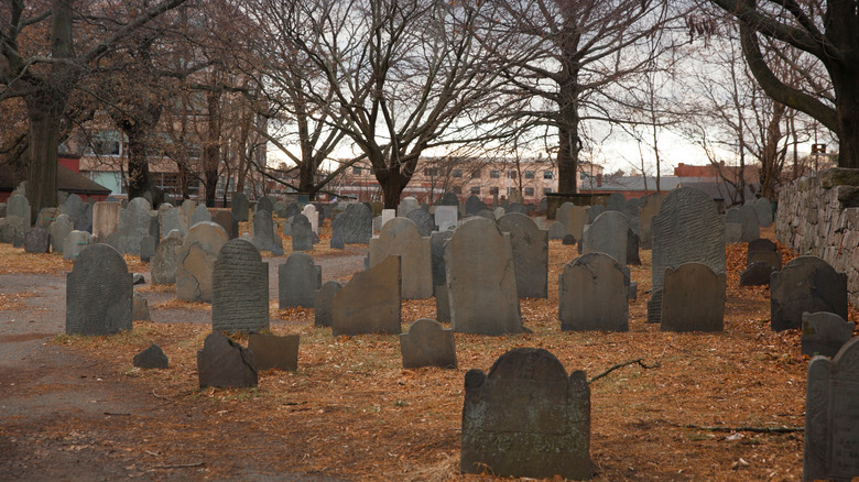 burial point execution site Salem gravestones autumn leaves