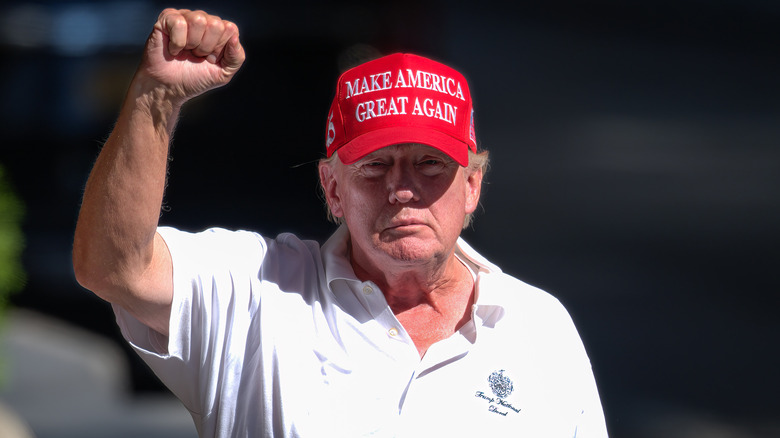 Trump with MAGA hat fist-bumping