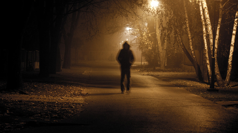 man in shadows walking