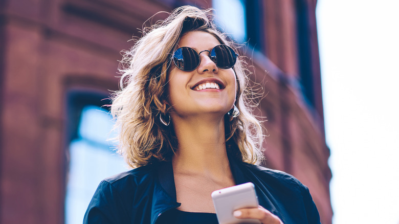 young woman holding a smartphone