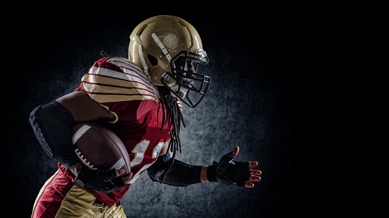 Football player running with ball