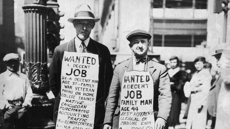 Men sandwich boards asking for jobs