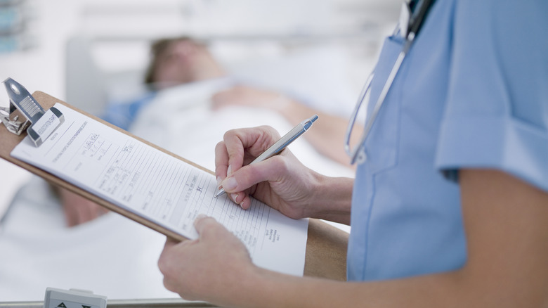 doctor clipboard patient bed