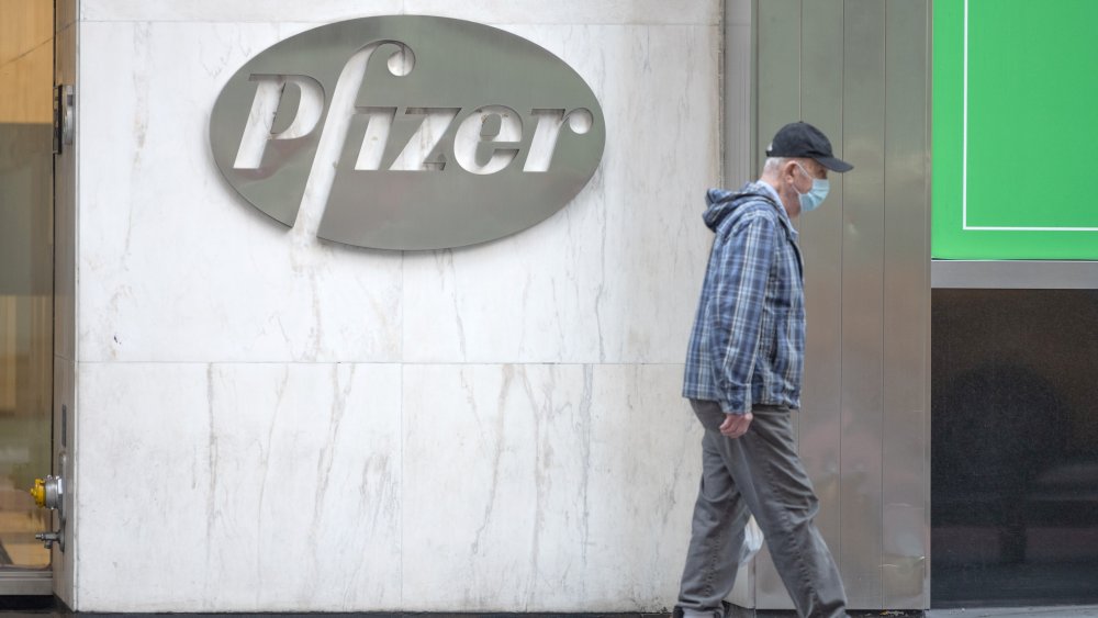Pfizer sign and masked man