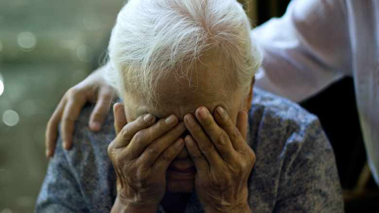 Distressed elderly woman