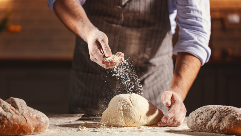 A baker kneading dough