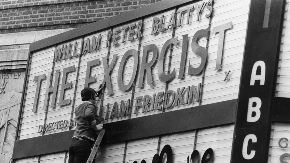 Man creating The Exorcist movie marquee