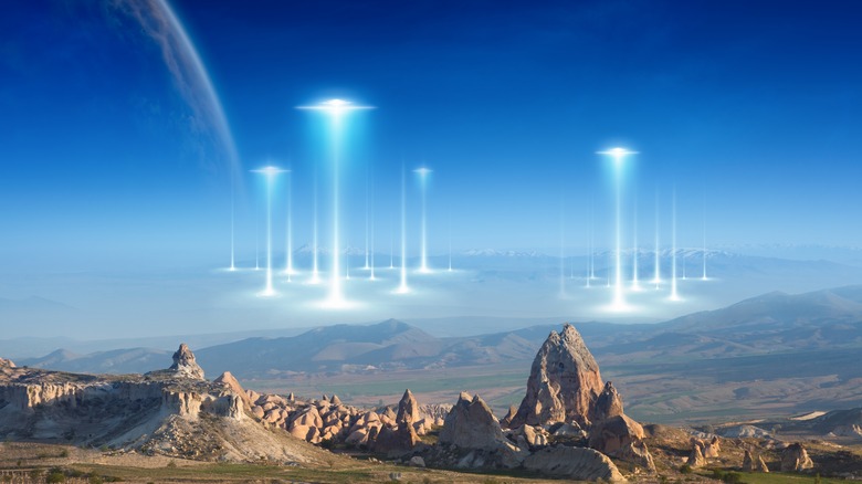 UFOs settling on landscape