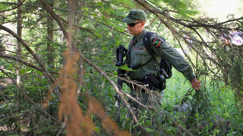 Police officer searching woods