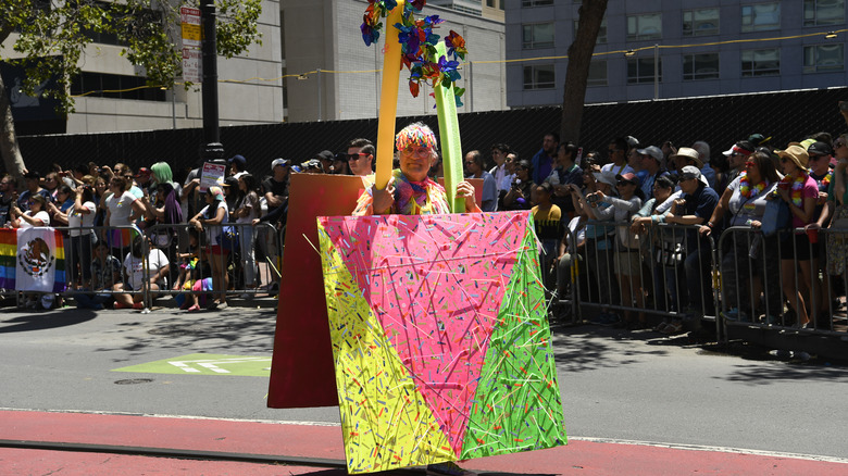 person wearing the pink triangle in a parade