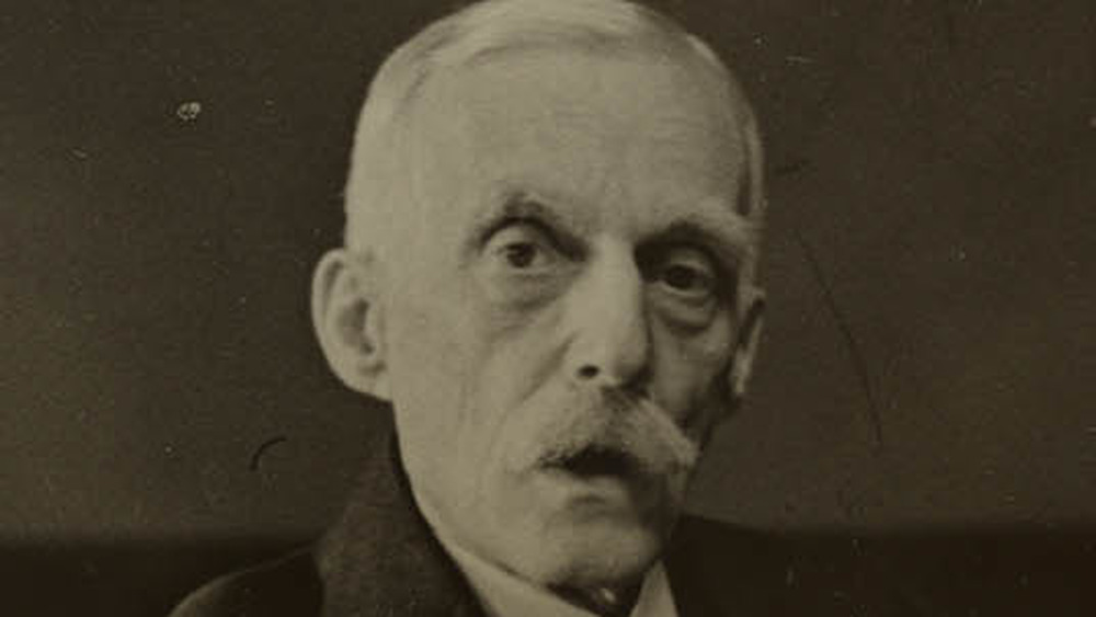 Andrew Mellon seated at desk