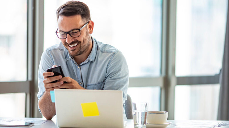 Man smiling while working