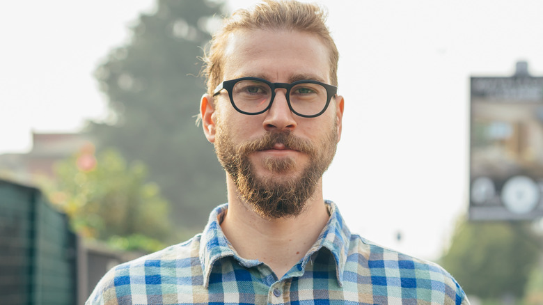 Man with glasses looking serious