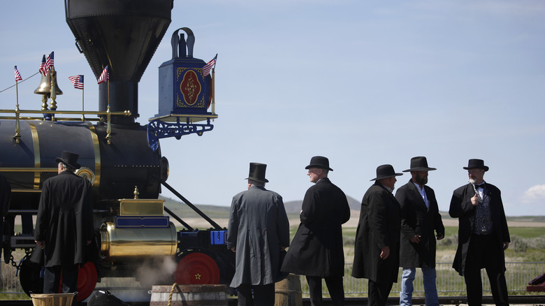 Reenactors boarding old-fashioned train 