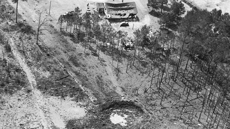 Mars Bluff crater and damaged building seen from above.