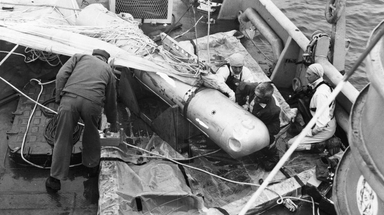 Crewmembers on submarine secure nuclear weapon pulled from sea near Palomares, Spain.